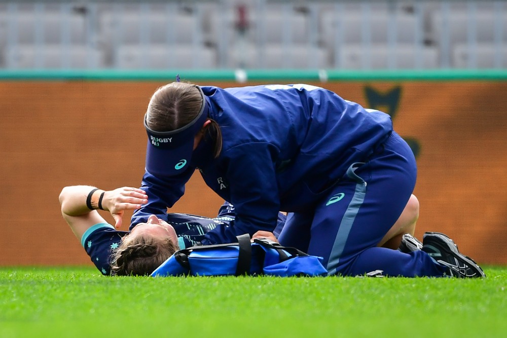 Wallaroos halfback Georgia Cormick is helped by medical staff after copping a ball to the face which has ruled her out of the Test against the Black Ferns. Photo: RUGBY.com.au/Stuart Walmsley