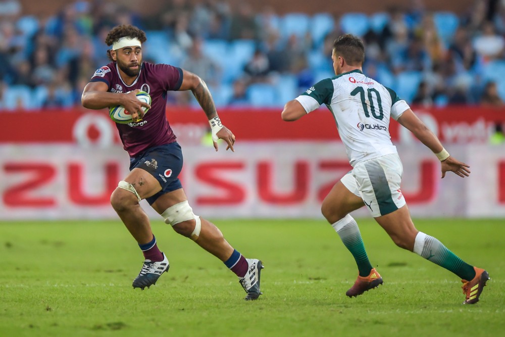 Lukhan Salakaia-Loto makes a run past Handre Pollard in the Reds' loss to the Bulls. Photo: AFP