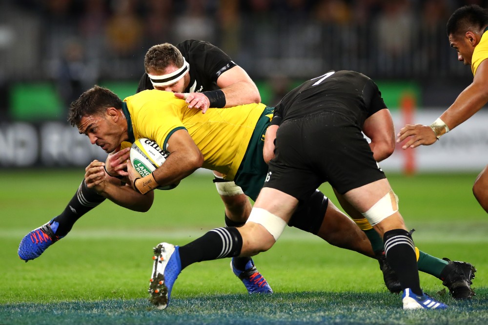 Rory Arnold is tackled by two All Blacks players in Perth. Photo: Getty Images 