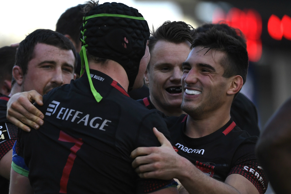 Liam Gill (left) celebrates his Lyon try. Photo: AFP