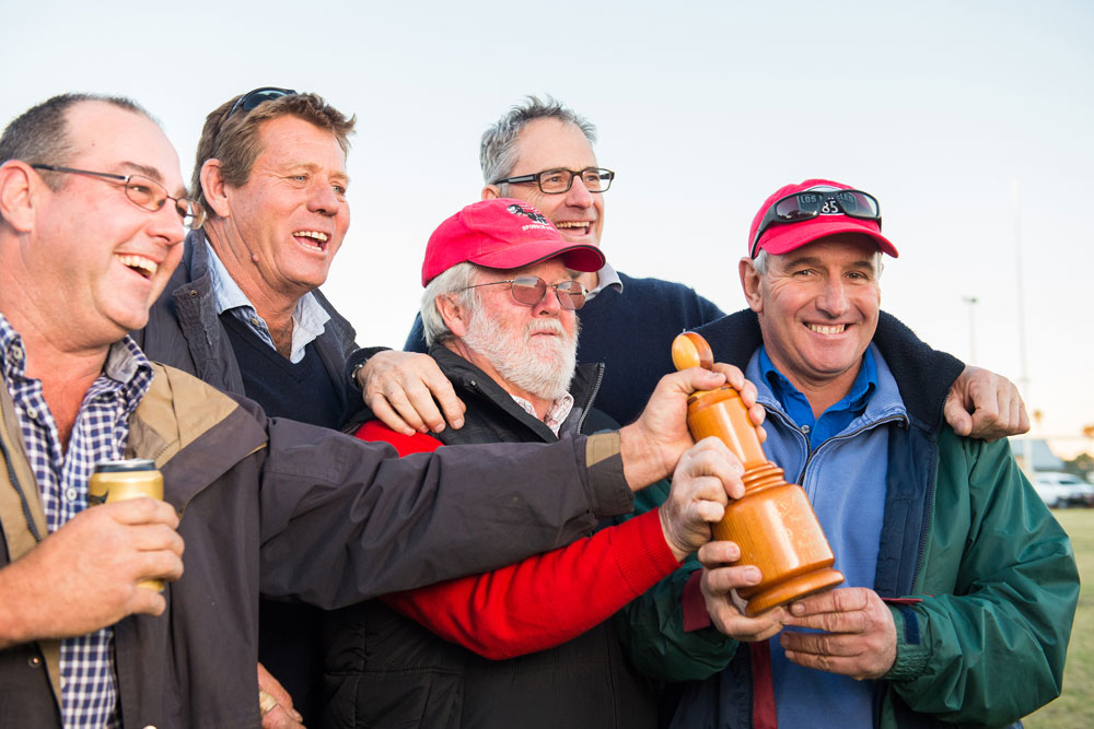 Ex Narromine players (left to right) Scott Richardson, James Rae, Anthony Tuck, Don Crosby and Graeme Powell rush to get their hands on The Ashes at full time. Photo: RUGBY.com.au/Stuart Walmsley