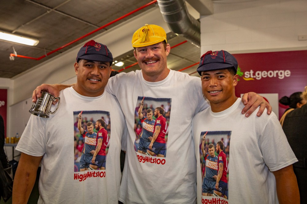 Gavin Luka (left) and Scott Malolua (right) celebrate their Reds debuts in the same match as Scott Higginbotham (centre) played his 100th game for the club. Photo: QRU Media/Brendan Hertel